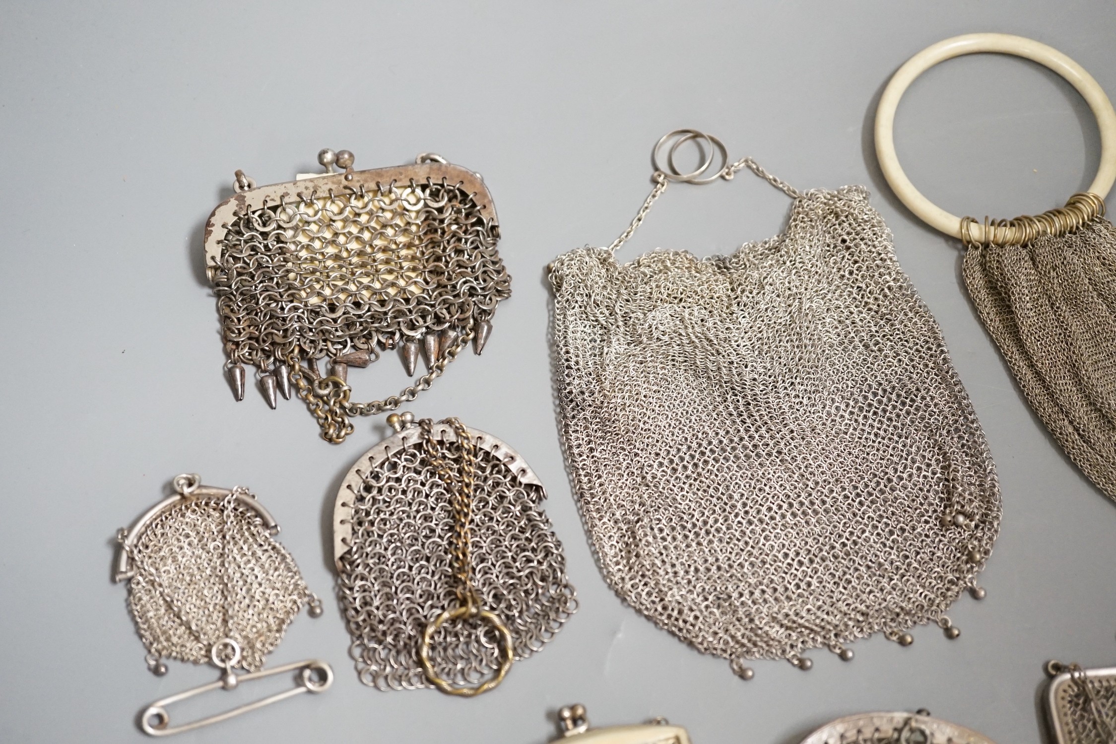 A stamped silver purse, together with eighteen metal chain mail purses and evening bags of various size, thickness and design